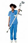 Orthopedic Lady Doctor With Crutches In Hand Stock Photo