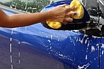 Outdoor Blue Car Wash With Yellow Sponge Stock Photo
