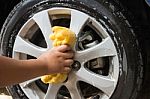 Outdoor Tire Car Wash With Yellow Sponge Stock Photo