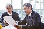 Partner Of Senior Engineering Working Man Serious Meeting About Project Discussing Solution Shot On Table In Office Meeting Room Stock Photo