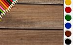 Pencils And Paints On A Background Of Dark Wood Tables Stock Photo