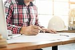 Person's Engineer Hand Drawing Plan On Blue Print With Architect Stock Photo