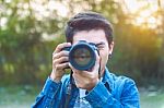 Photographer Taking Pictures With Digital Camera. Vintage Tone Stock Photo