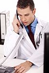 Physician Talking Over Phone Stock Photo