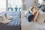 Pillows On Modern Bed With Grey Blanket Stock Photo
