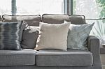 Pillows On Modern Grey Sofa In Living Room Stock Photo