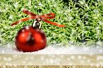 Pine Wood Table And Red Christmas Ball On Snow With Christmas Tree Stock Photo