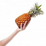 Pineapple In Female Hand On White Background Stock Photo