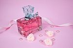 Pink Aromatic Perfume With Pink Pearls And Pink Textile Roses On Pink Background Stock Photo