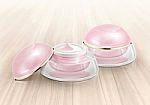 Pink Dome Cosmetic Jar On Wood Background Stock Photo