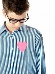 Pink paper heart shape in boy shirt Stock Photo