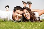 Playful Young Couple Laying Down Stock Photo