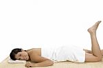 Pleased Woman Laying On Bamboo Mat Stock Photo