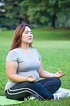 Plus Size Woman Practicing Yoga Stock Photo