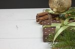 Polka Dot Gift With Christmas Decoration With Cinnamon And Pine Branches On White Wood Background Stock Photo