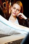 Portrait Of An Attractive Young Woman Who Reading Newspaper Stock Photo