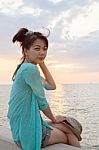 Portrait Of Asian Woman Relaxing Vacation Holiday At Sea Side With Sun Set Sky Background Stock Photo