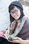 Portrait Of Beautiful Asian Woman Relaxing Time Reading Book On Cradle Happiness Emoton With Smiling Face Stock Photo