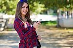 Portrait Of Beautiful Girl Using Her Mobile Phone In City Stock Photo