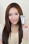 Portrait Of Beautiful  Smiling Asian Woman Is Holding Cosmetic C Stock Photo