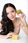 Portrait Of Beautiful Smiling Asian Woman Model Is Holding Cosme Stock Photo