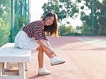 Portrait Of Beautiful Sport Girl Sitting In Tennis Courts  Looki Stock Photo