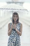 Portrait Of Beautiful Tan Skin Woman With Umbrella Standing Amon Stock Photo