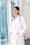 Portrait Of Confident Female Doctor In Lab Coat Stock Photo