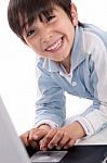 Portrait Of Cute Caucasian Boy Smiling With Laptop Stock Photo