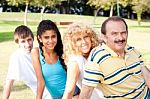 Portrait Of Family Relaxing In Park Stock Photo