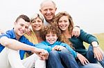 Portrait Of Family Sitting On Beach Lawn Stock Photo