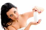 Portrait Of Female Posing With Lotion Bottle On An Isolated Background Stock Photo