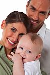 Portrait Of Happy Mother And Father With Baby Boy Stock Photo