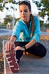 Portrait Of Running Woman Doing Stretching In The Park Stock Photo