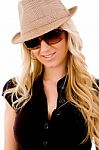 Portrait Of Smiling Female Wearing Hat And Sunglasses Stock Photo
