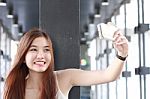 Portrait Of Thai Adult Beautiful Girl Using Her Smart Phone Selfie Stock Photo