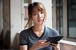 Portrait Of Thai Adult Beautiful Girl Using Her Tablet Stock Photo