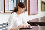Portrait Of Thai Adult Businesswoman Beautiful Girl Using Her Tablet Stock Photo