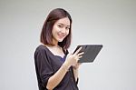 Portrait Of Thai Adult Student University Beautiful Girl Using Her Tablet Stock Photo