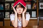 Portrait Of Thai Adult Student University Uniform Beautiful Girl Reading Red Book Stock Photo