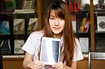Portrait Of Thai Adult Student University Uniform Beautiful Girl Using Her Tablet Stock Photo