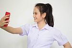 Portrait Of Thai High School Student Uniform Beautiful Girl Using Her Smart Phone Selfie Stock Photo