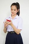 Portrait Of Thai High School Student Uniform Teen Beautiful Girl Using Her Phone And Smile Stock Photo