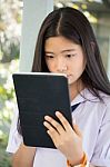 Portrait Of Thai Student Teen Beautiful Girl Using Her Tablet Stock Photo