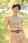 Portrait Of Young And Beautiful Asian Woman Standing In Park Wit Stock Photo