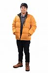 Portrait Of Young Asian Man Wearing Yellow Winter Jacket And Bla Stock Photo
