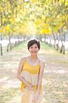 Portrait Of Young Beautiful Asian Woman Wearing Yellow Long Dres Stock Photo