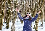Portrait Of Young Beautiful Woman Playing With Snow In The Woods Stock Photo