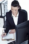 Portrait Of Young Business Woman Working At Her Office Stock Photo