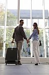 Portrait Of Young Couple With Luggage At Airport Stock Photo